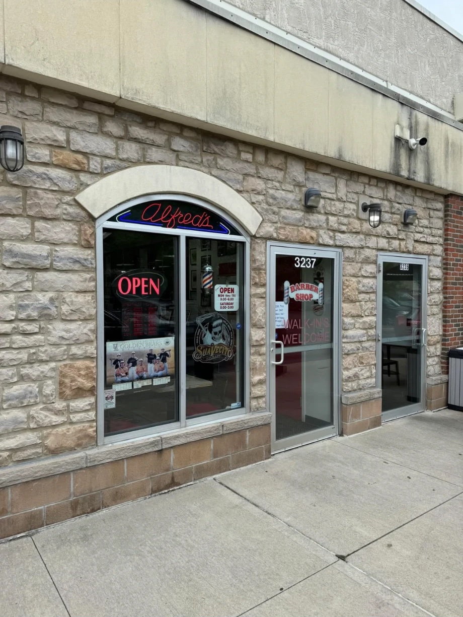 Alfred's storefront at 3237 Tremont Rd, with the red neon Alfred's sign and a Walk-ins Welcome door
